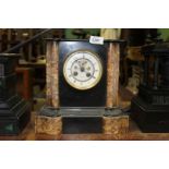 A slate and polished stone Mantle Clock by Henry Marc, Paris,