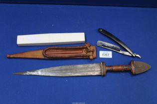 A cut throat razor and a ceremonial dagger in sheath.