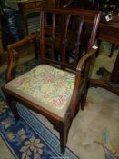 An elegant Georgian Mahogany open armed corner/elbow Chair having stylised floral bosses to the