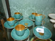 Six Royal Worcester coffee cups and saucers decorated in a blue/green pebble pattern having gilt