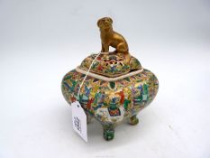 An Oriental diamond shaped footed and lidded pot with scenes of Elephants and sages with papers at