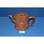 A Chinese terracotta Teapot having blossom relief, 5 1/2'' tall, lid chipped.