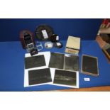 A box containing a box of old glass photographic plates and four cine movies- Redskin Raiders,