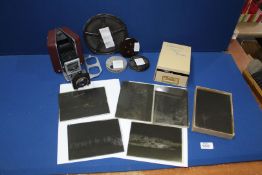A box containing a box of old glass photographic plates and four cine movies- Redskin Raiders,
