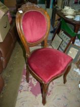 A dark-wood framed maroon fabric upholstered cameo back Side Chair standing on cabriole front legs.