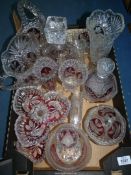 A quantity of pressed glass with cranberry panels including; vases, decanters, basket, etc.