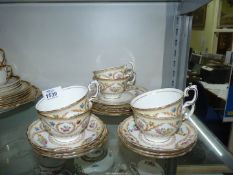 A Crown Staffordshire teaset for six decorated with pastel coloured flowers in laurel sprigs and