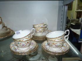 A Crown Staffordshire teaset for six decorated with pastel coloured flowers in laurel sprigs and