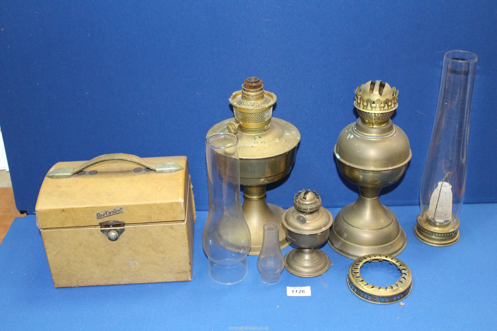 A Sky casket radio plus three old oil lamps with chimneys.