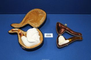 Two cased unsmoked meerschaum Pipes, the larger one carved as Dionysus, God of Wine,