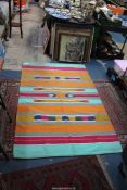 A sturdy Turkish Kelim in vibrant blues, orange and pink stripes, 3' 9" x 6'.