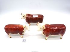 Two Beswick Hereford Bull figures and one Hereford cow figure, one horn chipped,