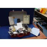 A red travel case and contents to include; photographs, hand books, lace veil,