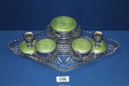 A vintage six piece dressing table set in green comprising three lidded jars,