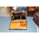 A cased Singer hand sewing machine ELO69864