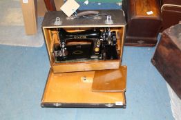 A cased Singer hand sewing machine ELO69864