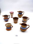 Seven items of 19th c copper lustre to include a pink lustre goblet , jugs, mugs etc.