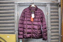 A ladies size 8 quilted Barbour jacket in metallic purple, with tags.