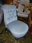 An Edwardian pale blue Dralon upholstered buttoned back Chair standing on turned front legs with