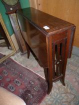 An arts and crafts Mahogany Sutherland Table having fretworked end supports,