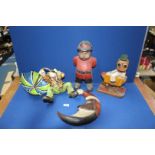 Four novelty treen figures including Duck, Man in the Moon, Clown in the Wind and a Policeman.