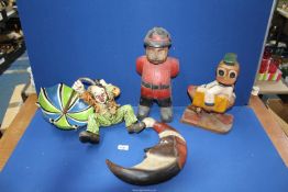 Four novelty treen figures including Duck, Man in the Moon, Clown in the Wind and a Policeman.