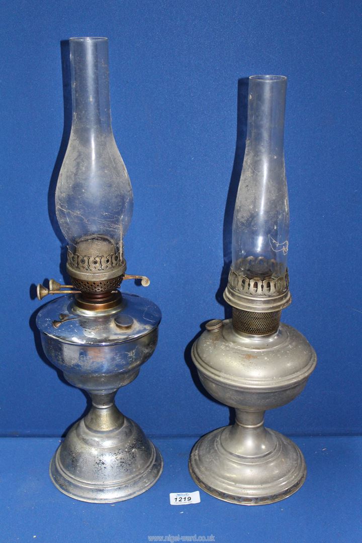 Two chrome effect oil lamps with chimneys , one being Aladdin.