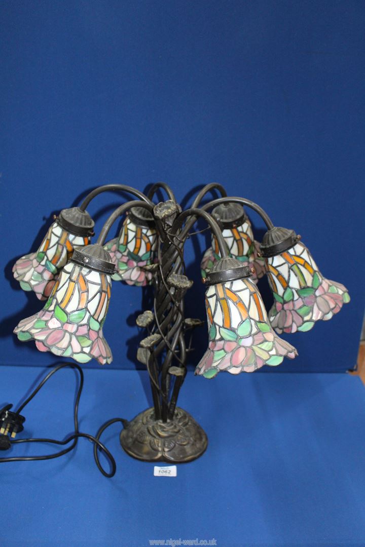 A six branch floral Tiffany style Lamp with entwined leaf base, 18 3/4'' tall.