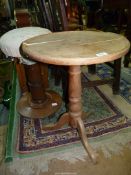 An Oak circular topped Table having a turned pillar and three splayed feet,