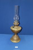 A brass oil lamp with glass chimney, 22 1/4" tall overall.