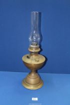 A brass oil lamp with glass chimney, 22 1/4" tall overall.