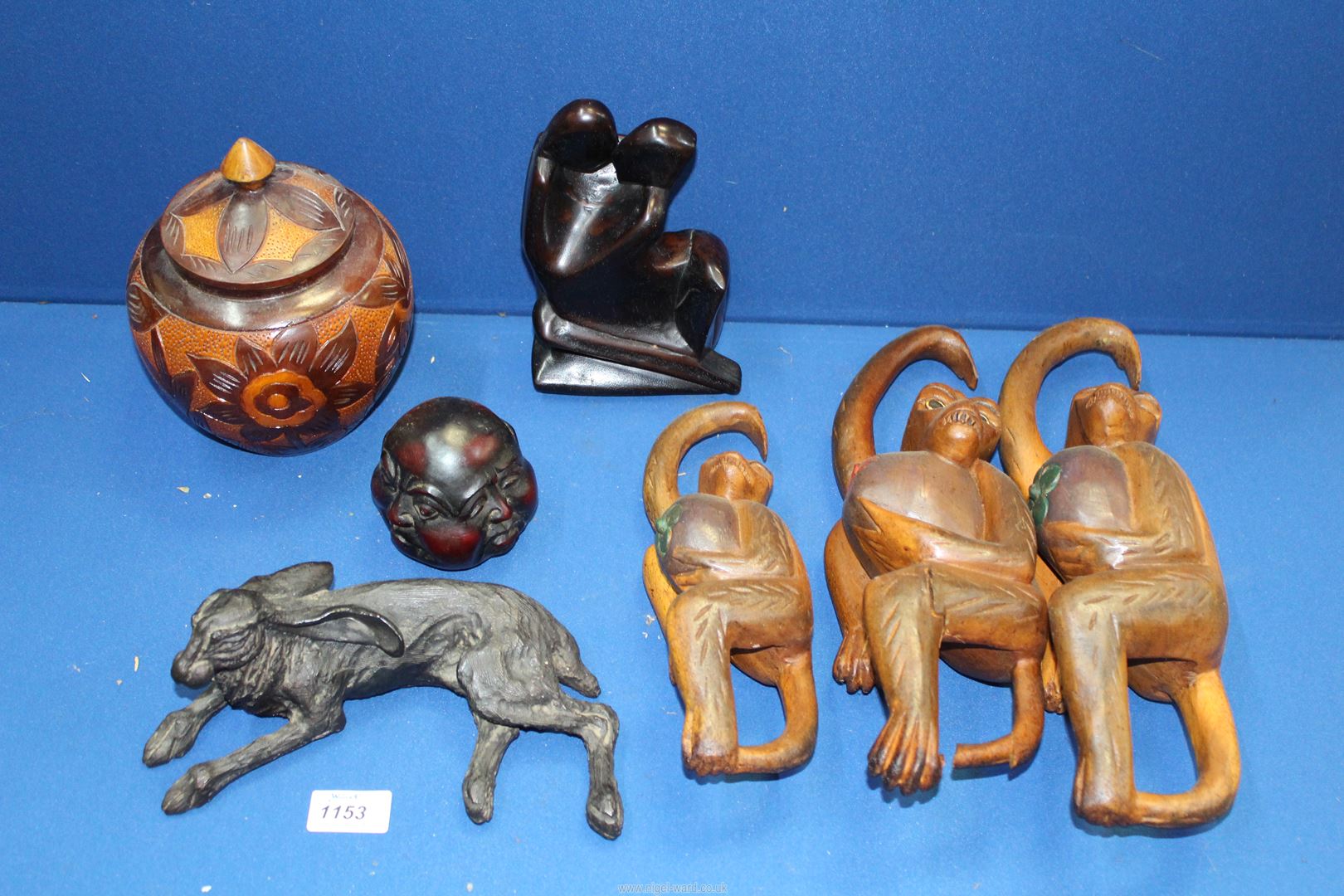 A quantity of treen including; Three orangutans (one a/f), four faced Buddha head,