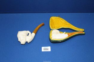 Two meerschaum Pipes, one pipe cased, carved with the head of a bearded Arab with headdress,