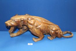 A large carved model of a Tiger, 23" x 8".