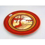 An Elements of Fire Deco style Charger with bright red rim, centre scene of orange/red trees,