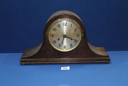 A Napolean hat shaped mantle Clock having Arabic numerals, 17" wide x 9 1/2" high.