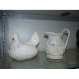 Two pieces of Portmeirion china; a white hen on nest and a Heritage Collection jug.