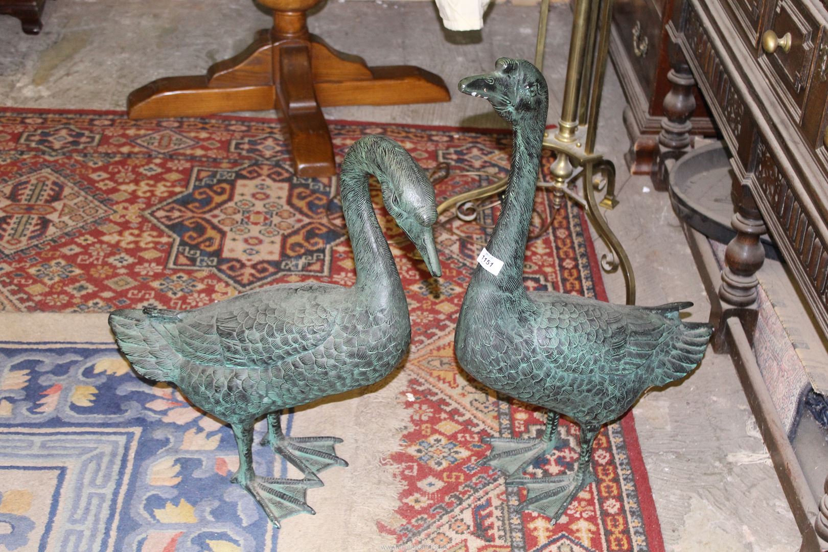 A large pair of metal ornamental Swans having verdigris finish, the tallest 28 1/2''.