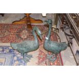 A large pair of metal ornamental Swans having verdigris finish, the tallest 28 1/2''.