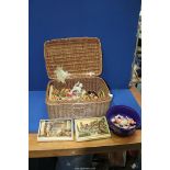 A wicker basket and contents of Ivorex plaques, Berg Austria wool and cotton small soft toys (cat,