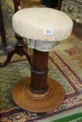 A Mahogany pedestal piano stool (needs re-upholstering), 23" tall.