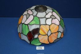 A Tiffany style lamp shade in mauve, orange, green and grey floral design, 10" diameter.