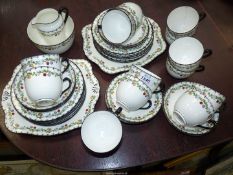 A Tuscan tea set for 14, including cups and tea plates, twelve saucers, bread and butter plates,