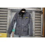 A ladies size 8 quilted Barbour jacket with belt in navy.