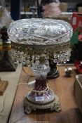 A very heavy glass lamp having pressed glass base with purple highlights and droppers on the shade,