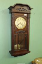 A Mahogany framed Wall clock having a two train spring drive movement striking on a gong,