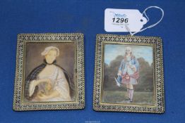 A pair of miniature Watercolour portraits in ornate openwork metal frames;