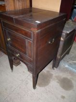 A Mahogany Campaign Washstand having a hinged clam shell action top and with a lift-up sliding