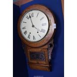 A Wall Clock in a carved and inlaid case with pendulum, key and winder, 27'' high, some damage.