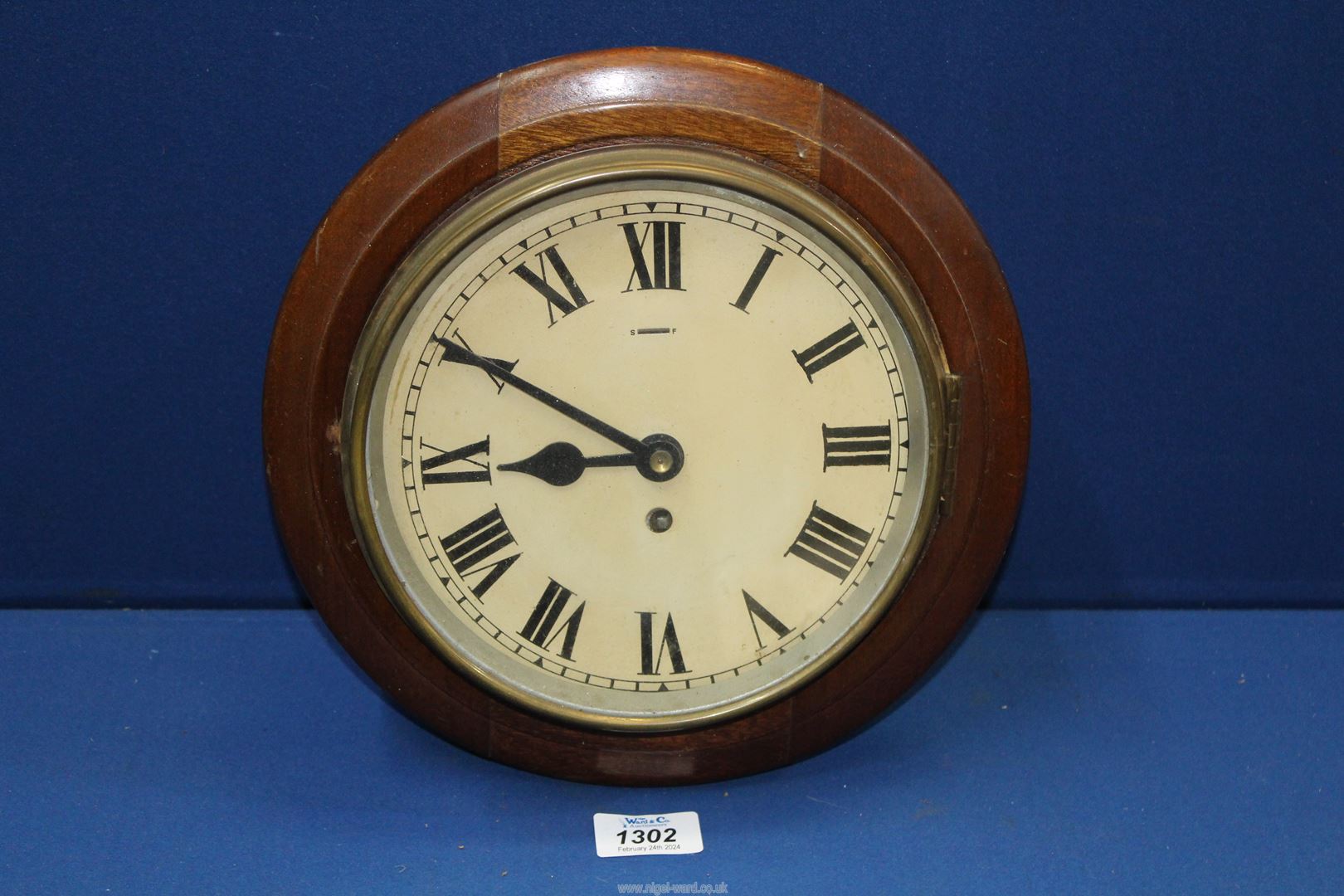 A circular wooden framed Wall Clock having Roman numerals - needs a little attention, 11" diameter.